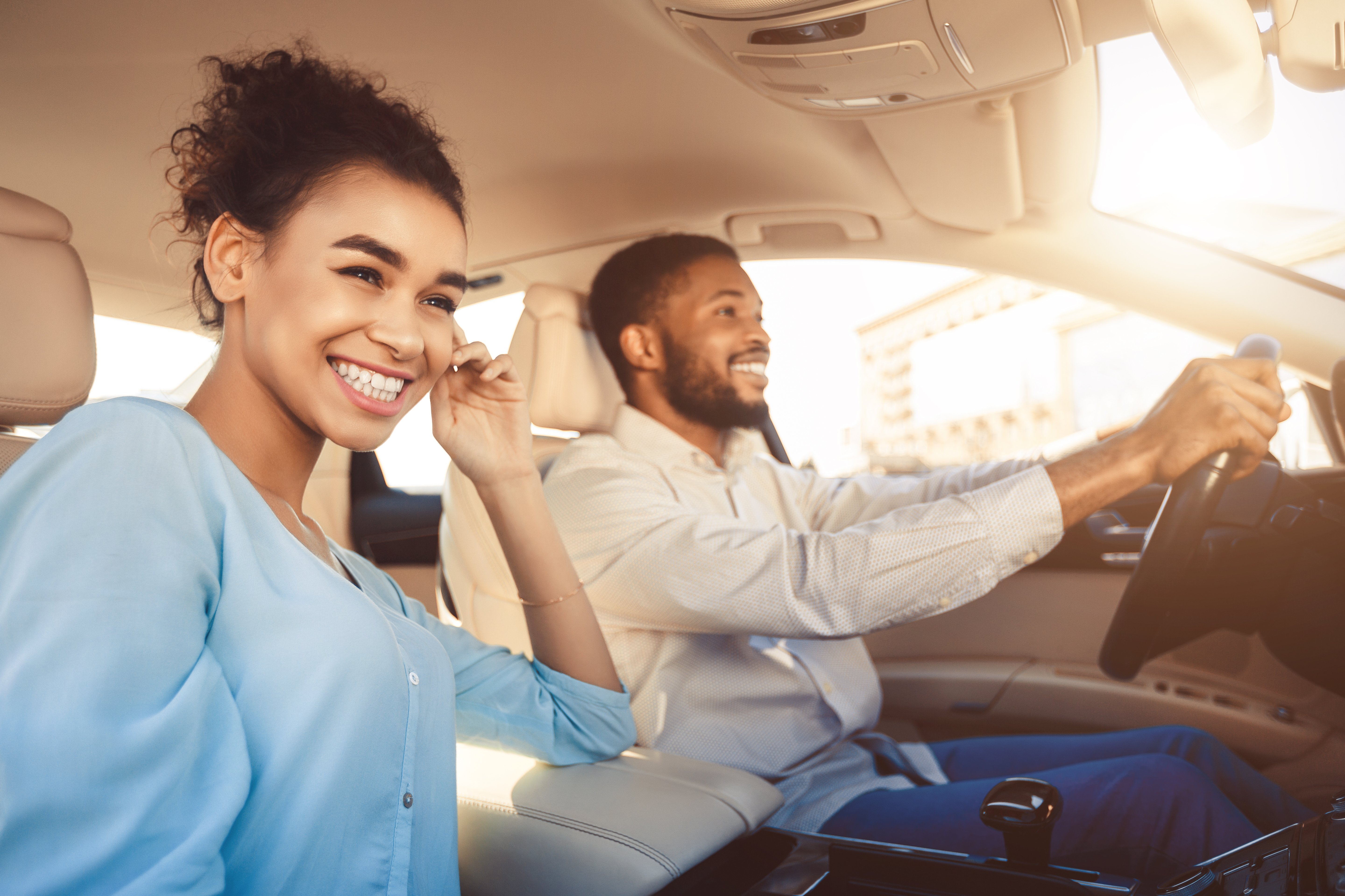 Couple smiling in a car after buying a car with a WEOKIE auto loan,