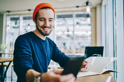 a man uses a Mobile App to manage his checking account.