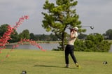 Participant taking a swing on the green during the 20th Annual WEOKIE Foundation Golf Classic