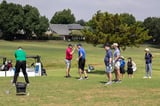 Participants high-fiving on the course during the 20th Annual WEOKIE Foundation Golf Classic