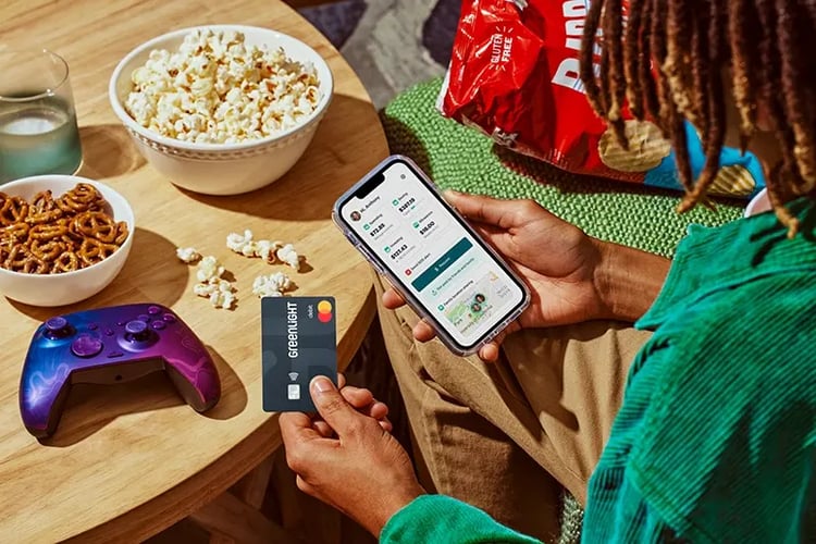 Greenlight app displaying allowance and spending features on mobile with debit card