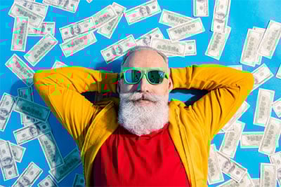 Man-Lying-on-bed-of-cash-home-page-image