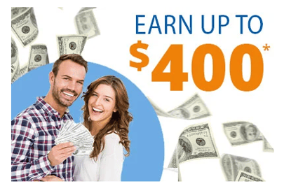 Couple holding money and smiling. 