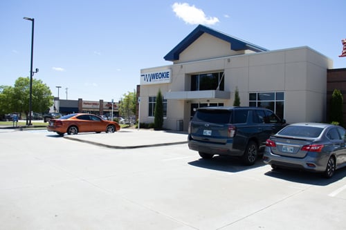 Exterior view of the WEOKIE Federal Credit Union Moore location building and parking lot.