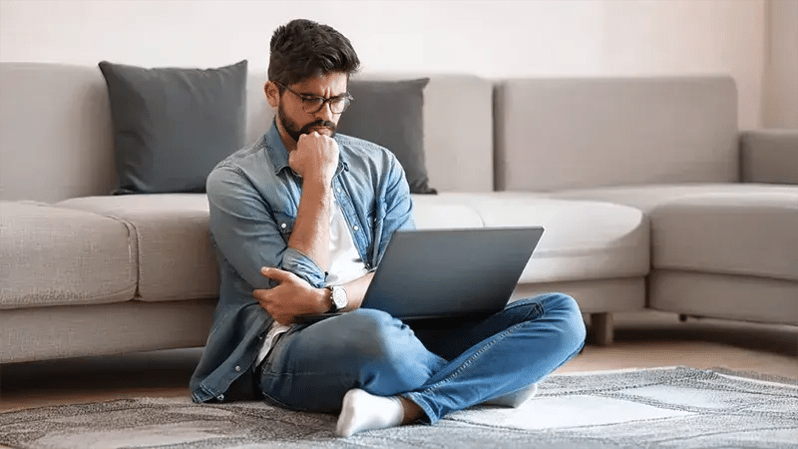 Man reviewing financing options on a laptop for a WEOKIE Smart Path auto loan