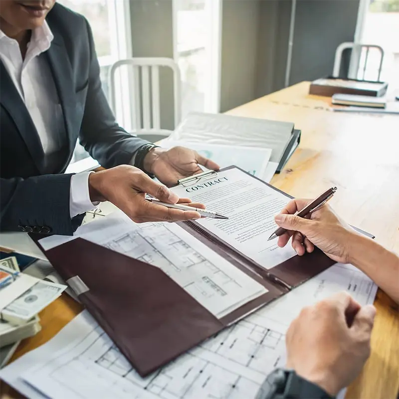 Commercial loans and credit services with business professionals reviewing loan documents for commercial property financing