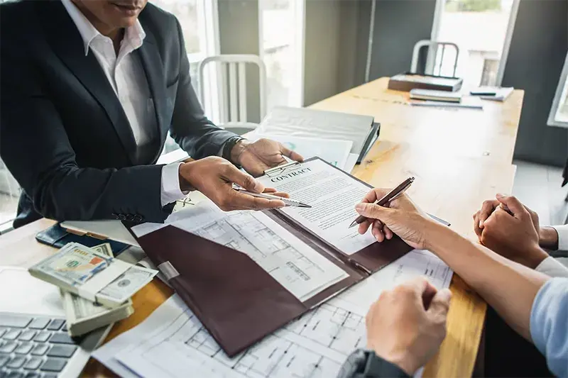 Business loan documents and financial paperwork on a conference table
