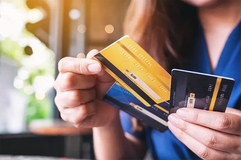 Person holding multiple credit cards