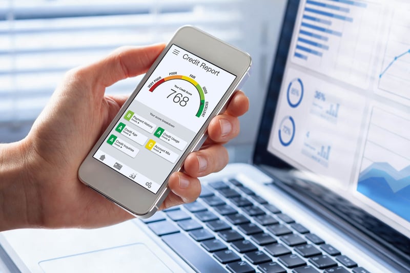 Close-up of a smartphone displaying a credit score and financial dashboard for real-time credit monitoring