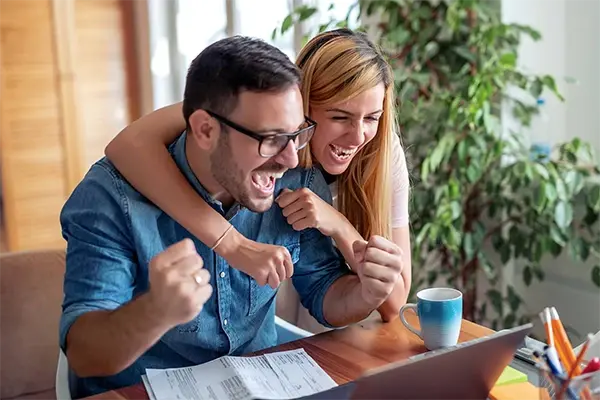 People using a laptop to manage checking account finances online