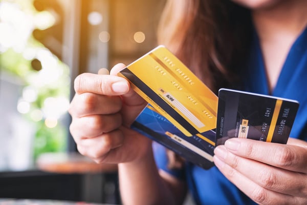 Close-up of hands holding multiple credit cards for convenient mobile purchasing and everyday spending