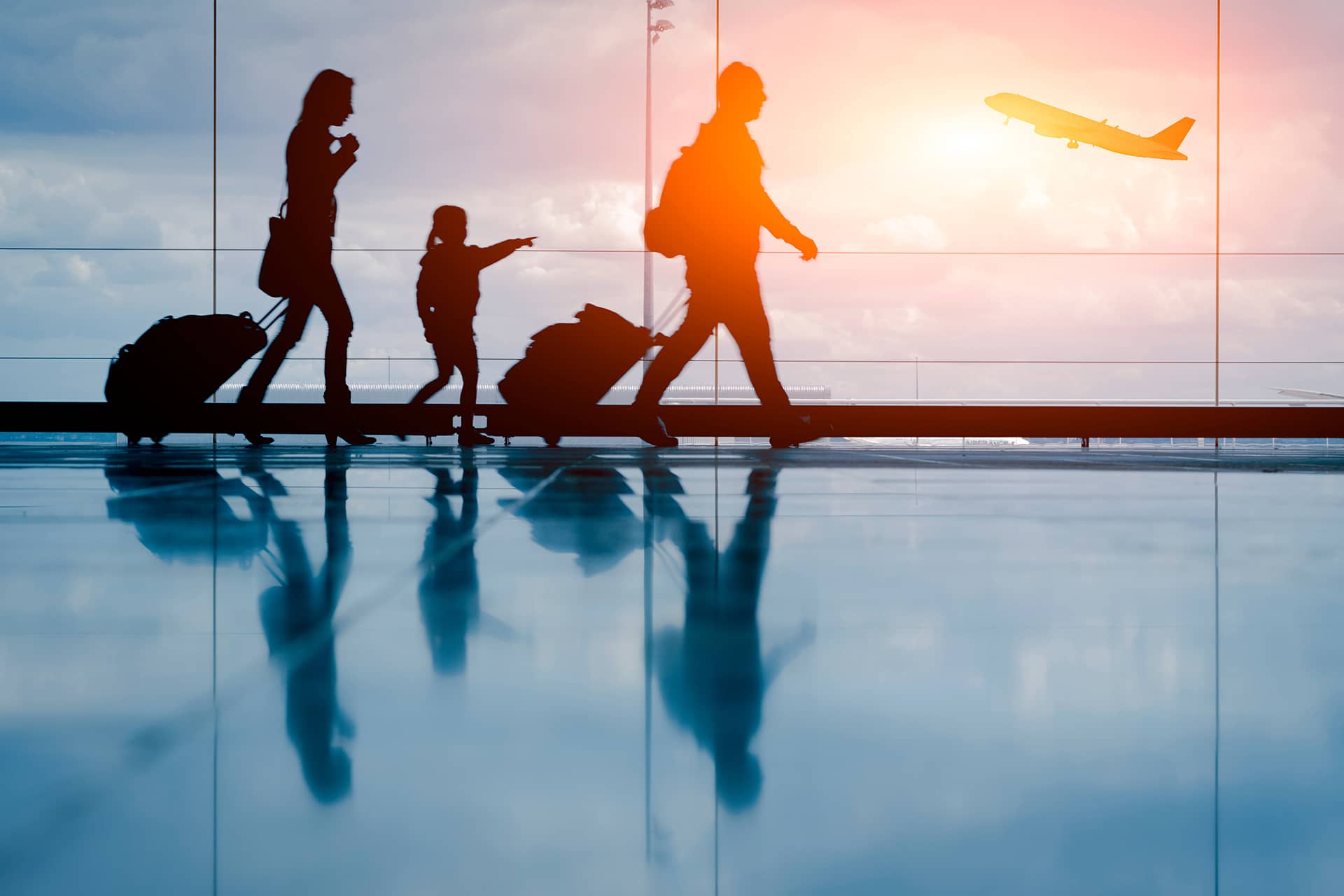 A family walking through an airport while traveling.