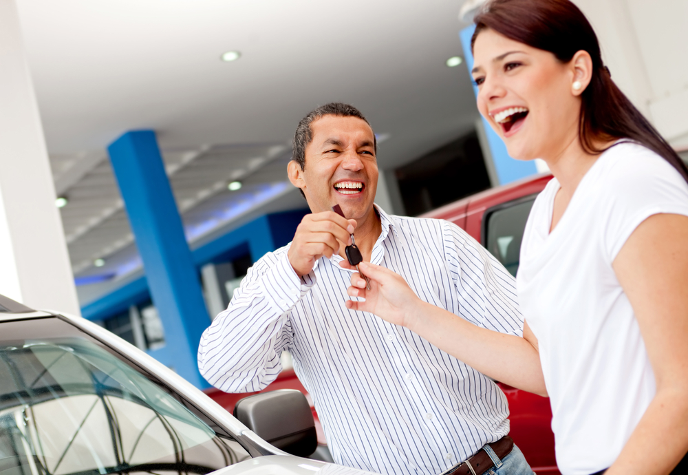 Man buying a car for his wife and handling her the keys